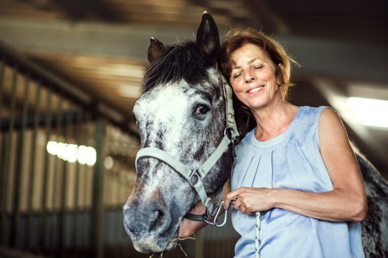 senior horse woman hug